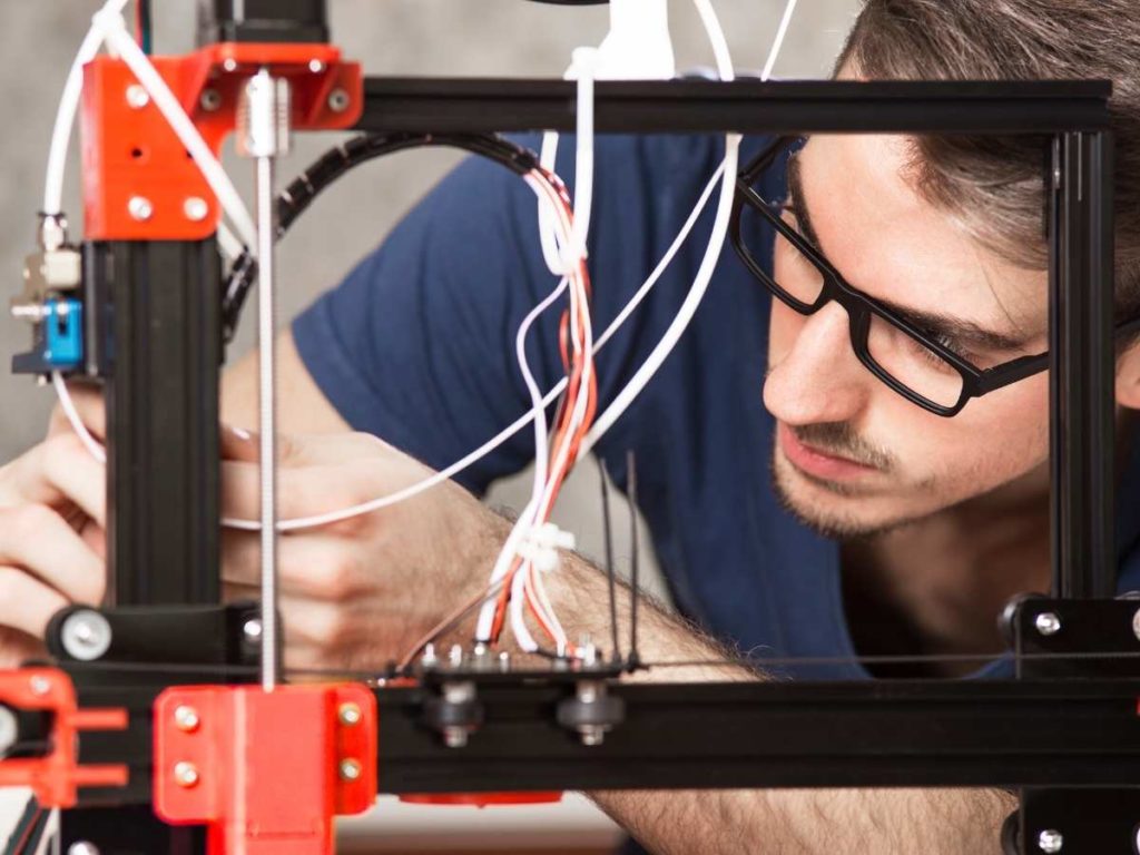a man checking the z-axis on his 3d printer