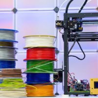 3d printer with a stock of old filament spools