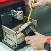 dlp resin 3d printer and person removing object from built plate