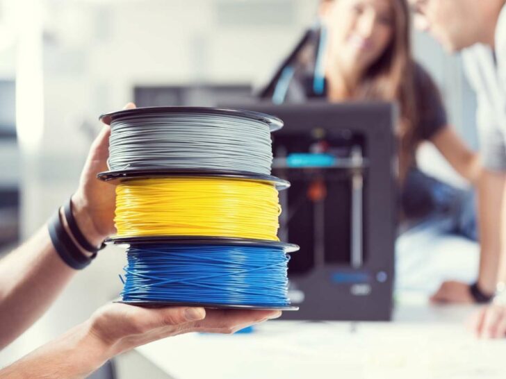 3d printer filament with a 3d printer in the background
