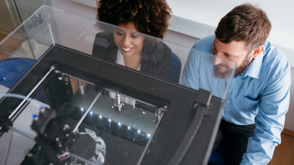 woman and man looking at their 3d printer