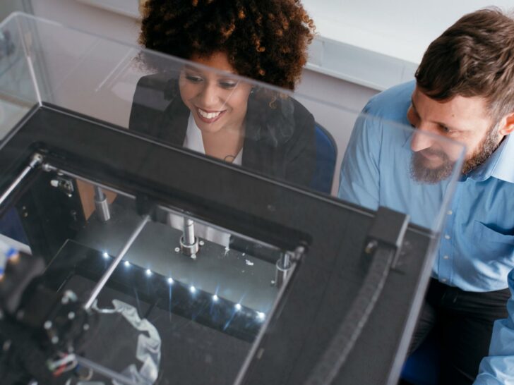 woman and man looking at their 3d printer