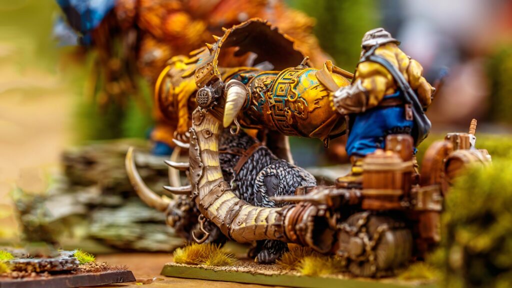 Fantasy miniature figure with a cannon in a detailed tabletop game setup