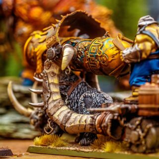 Fantasy miniature figure with a cannon in a detailed tabletop game setup